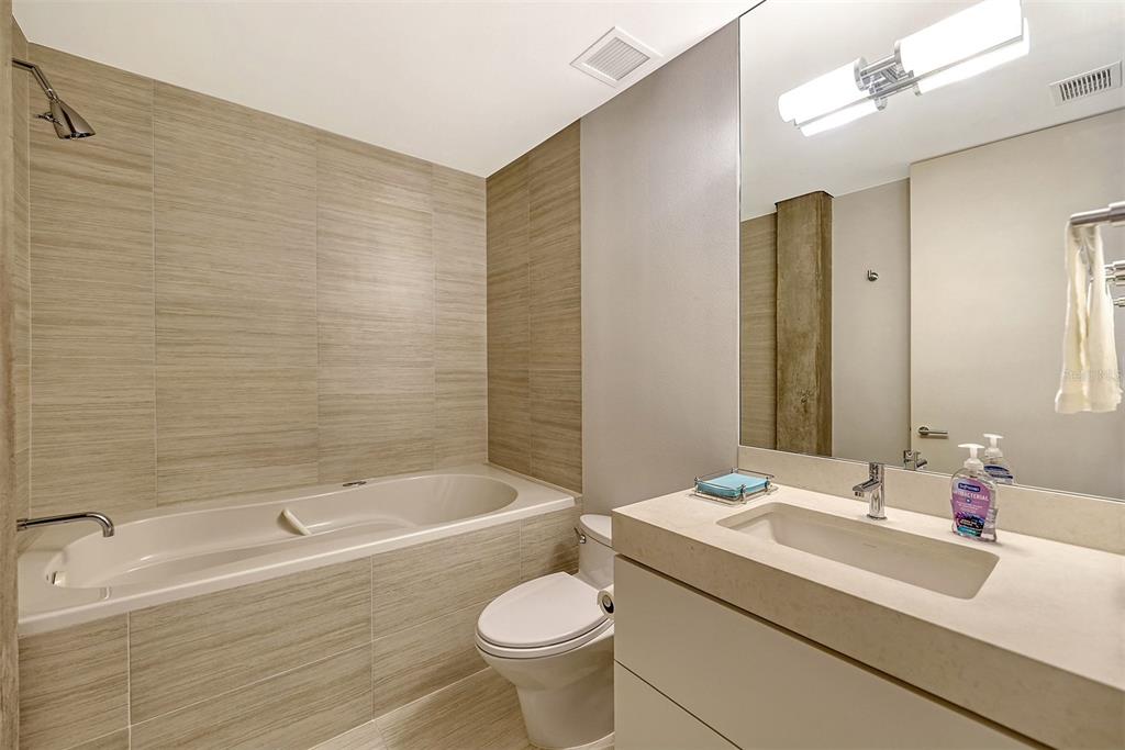 8250 Sanderling Road Sarasota, FL 34242 - Photo 34 of 61 a bathroom with a sink a toilet and shower