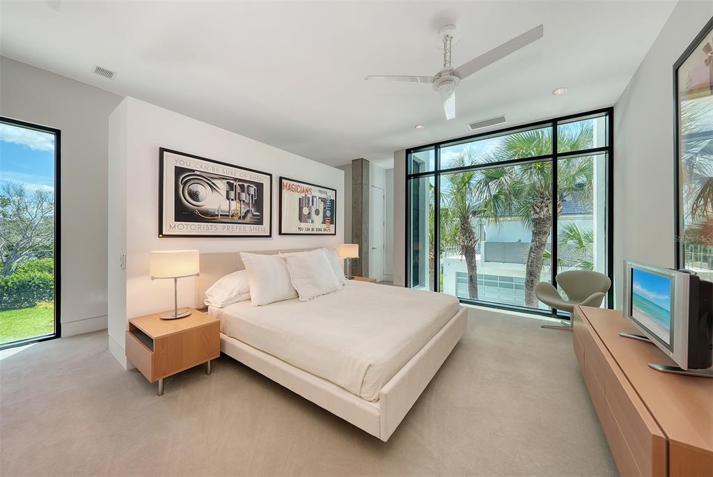 8250 Sanderling Road Sarasota, FL 34242 - Photo 35 of 61 a bedroom with a large bed and a large window