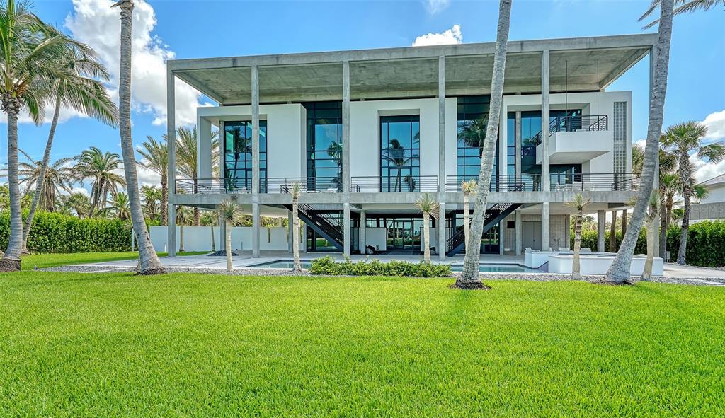8250 Sanderling Road Sarasota, FL 34242 - Photo 49 of 61 a view of a house with a yard and sitting area