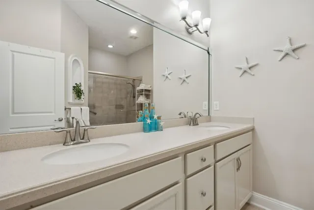 a bedroom with two beds and a mirror