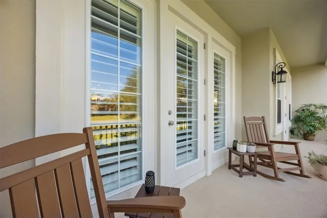 a view of a chairs and table on the balcony