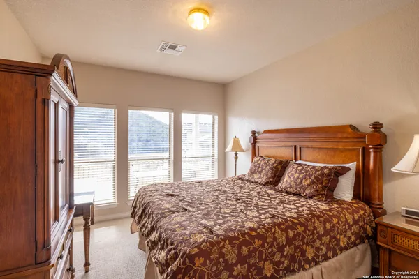 a bedroom with a large bed and a large window