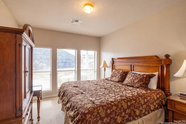 a bedroom with a large bed and a large window