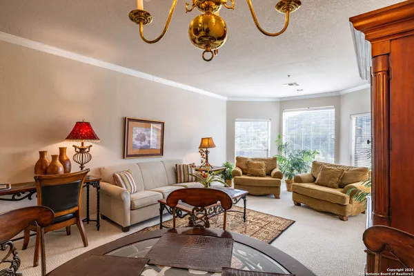 a living room with furniture chess table and a large window