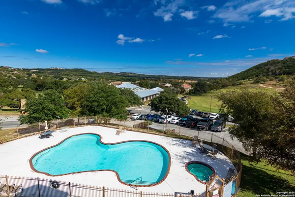 a view of a swimming pool with lawn chairs