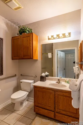 a bathroom with a toilet a sink and mirror