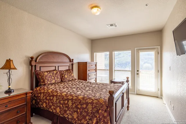 a bedroom with a large bed and a large window