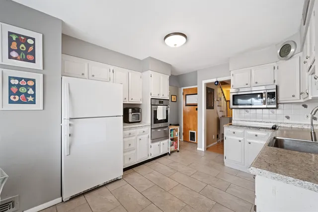 a kitchen with stainless steel appliances a refrigerator sink and cabinets