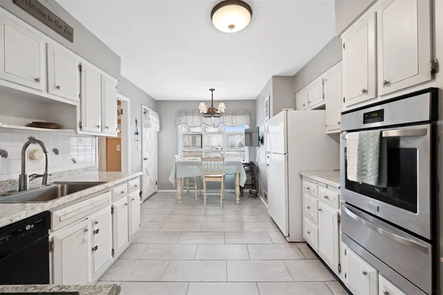 a kitchen with stainless steel appliances a refrigerator sink and cabinets