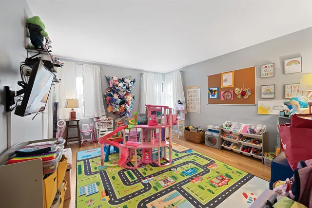 a bed room with furniture and a flat screen tv