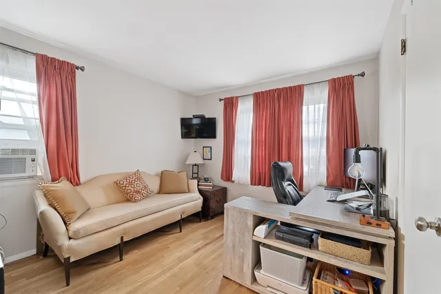 a living room with furniture a rug and a window