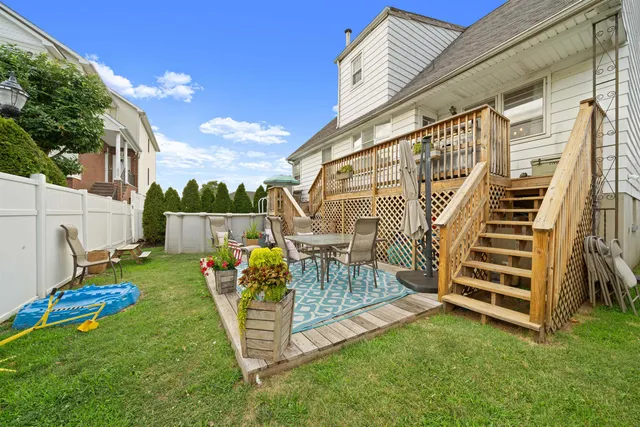 a view of a chair and table in the backyard
