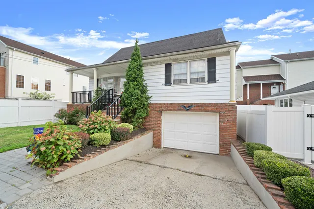 a front view of a house with a yard and a garage