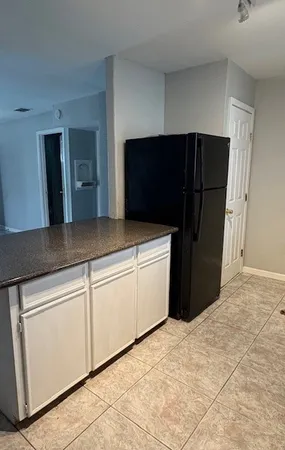a kitchen with stainless steel appliances kitchen island a refrigerator sink and cabinets