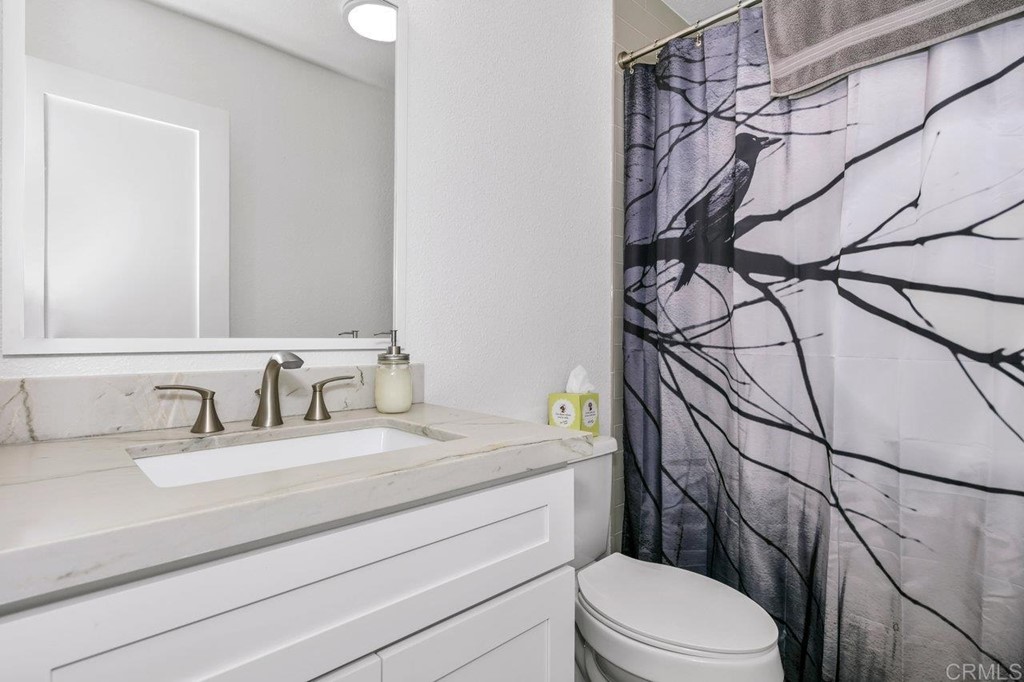 6972 Batiquitos Drive Carlsbad, CA 92011 - Photo 12 of 36 a bathroom with a sink a toilet and shower