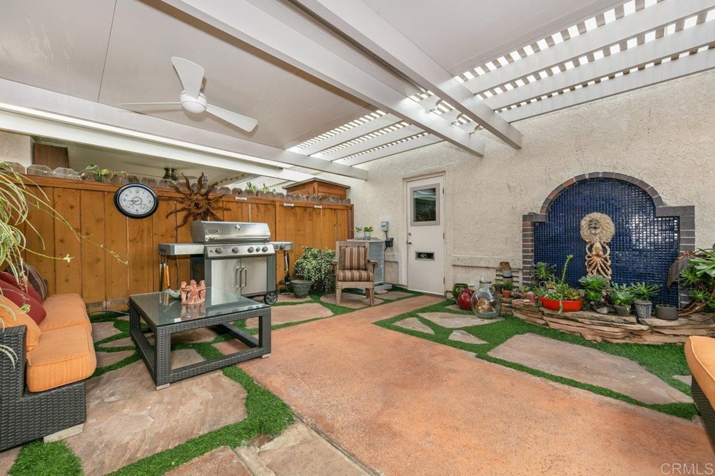 6972 Batiquitos Drive Carlsbad, CA 92011 - Photo 14 of 36 a living room with furniture a fireplace and a chandelier