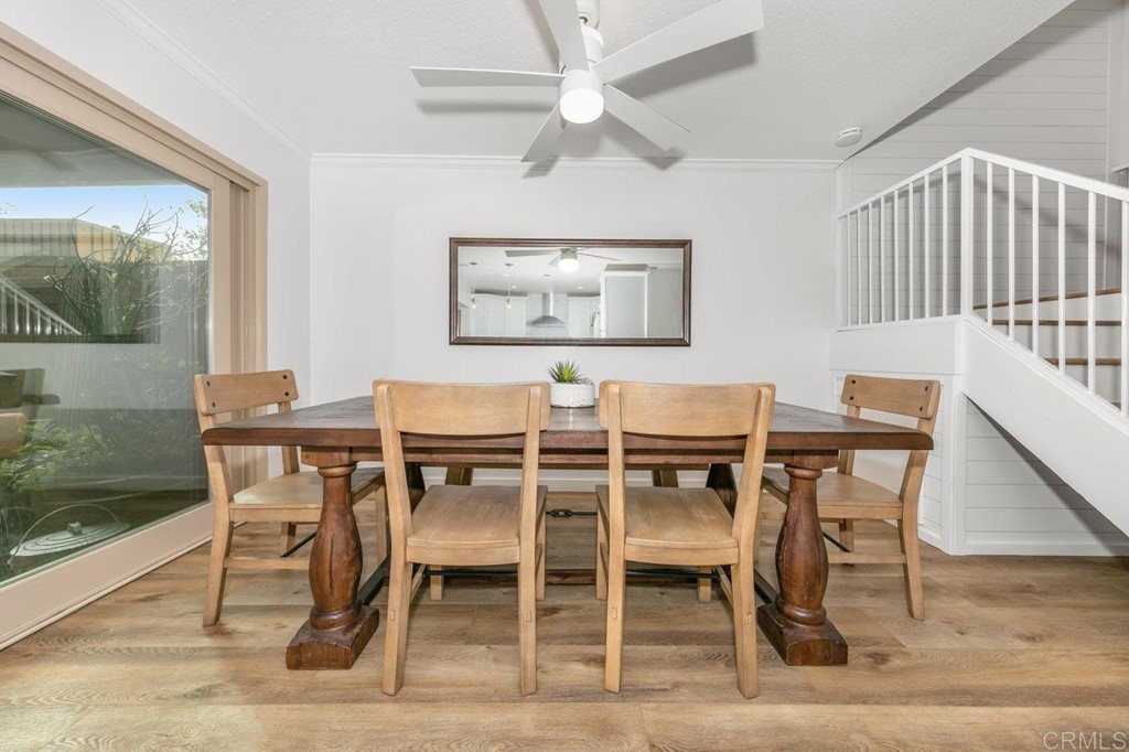 6972 Batiquitos Drive Carlsbad, CA 92011 - Photo 17 of 36 a dining room with wooden floor a glass table and chairs