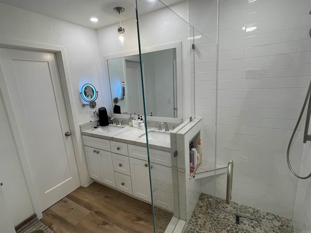 6972 Batiquitos Drive Carlsbad, CA 92011 - Photo 25 of 36 a bathroom with a double vanity sink mirror and toilet