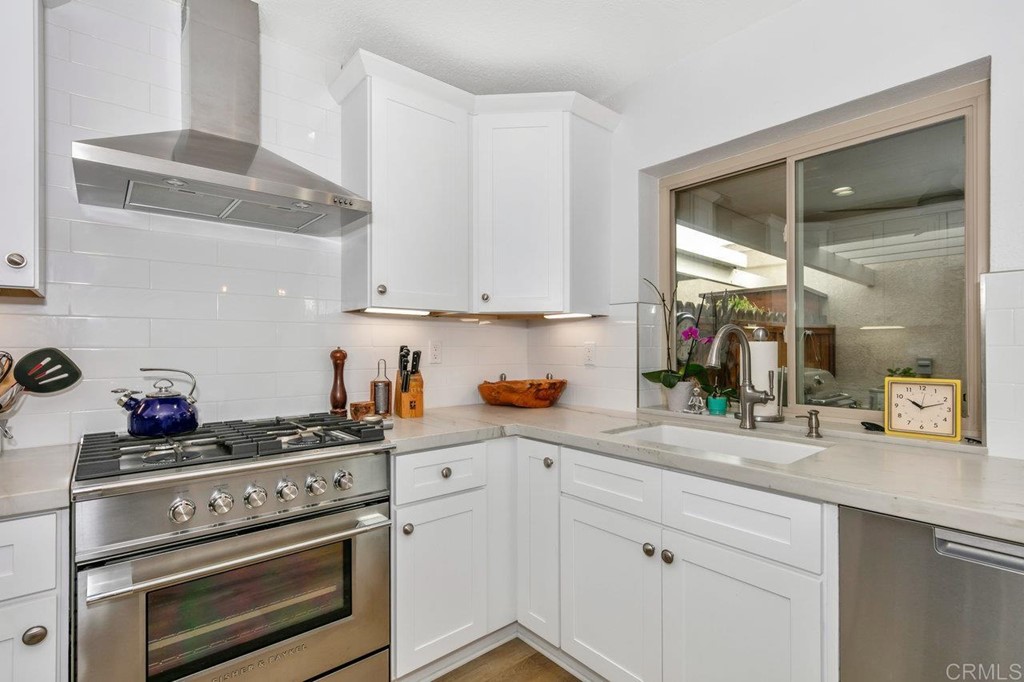 6972 Batiquitos Drive Carlsbad, CA 92011 - Photo 3 of 36 a kitchen with white cabinets and appliances