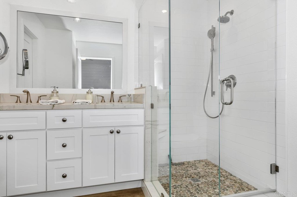 6972 Batiquitos Drive Carlsbad, CA 92011 - Photo 8 of 36 a bathroom with a granite countertop sink and a mirror