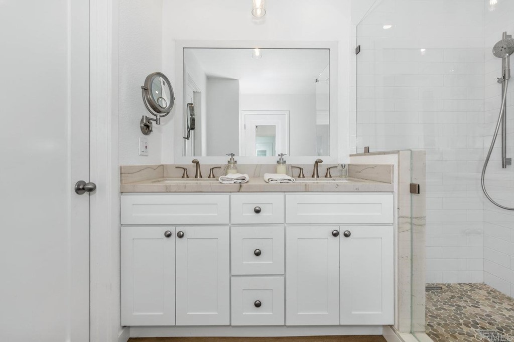 6972 Batiquitos Drive Carlsbad, CA 92011 - Photo 9 of 36 a bathroom with a sink vanity and a mirror