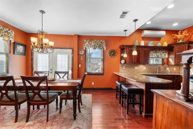 a dining room with furniture window and wooden floor