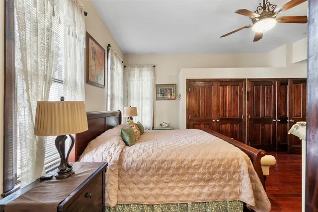 a bedroom with a bed and dresser with mirror