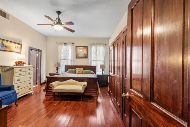 a bedroom with a bed and wooden floor