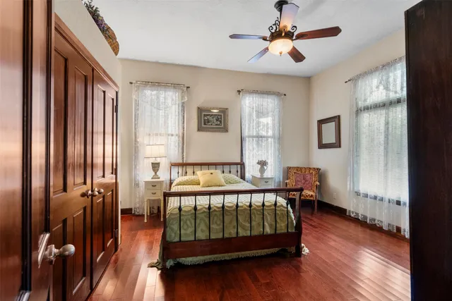 a bedroom with bed and wooden floor