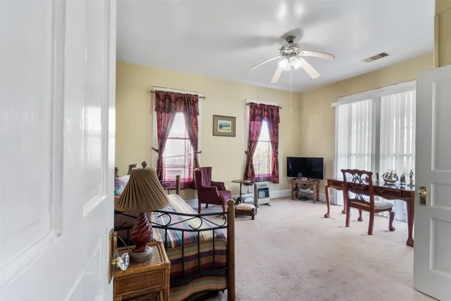 a view of a livingroom with furniture and a window