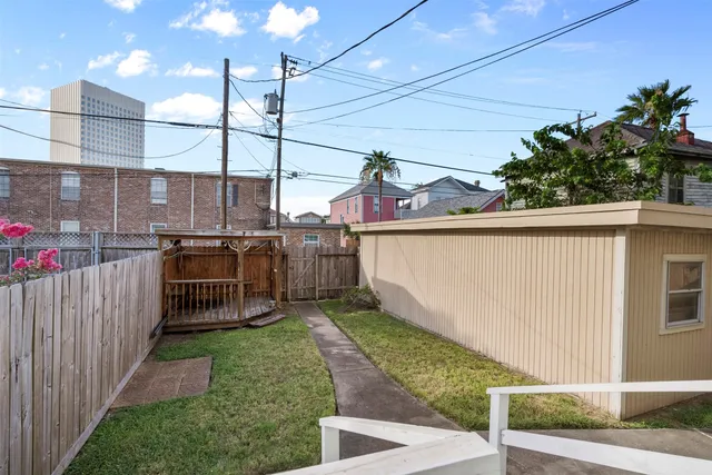 a view of a backyard with a wooden fence