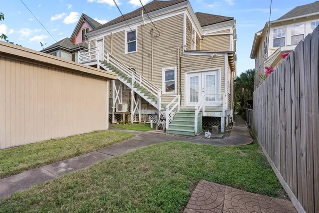 a view of a house with a yard and stairs