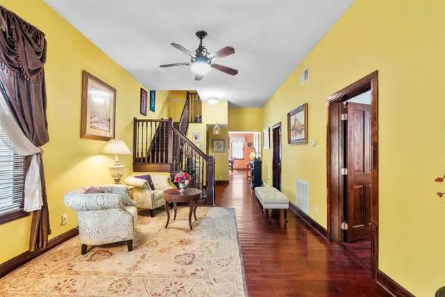a living room with furniture and a chandelier