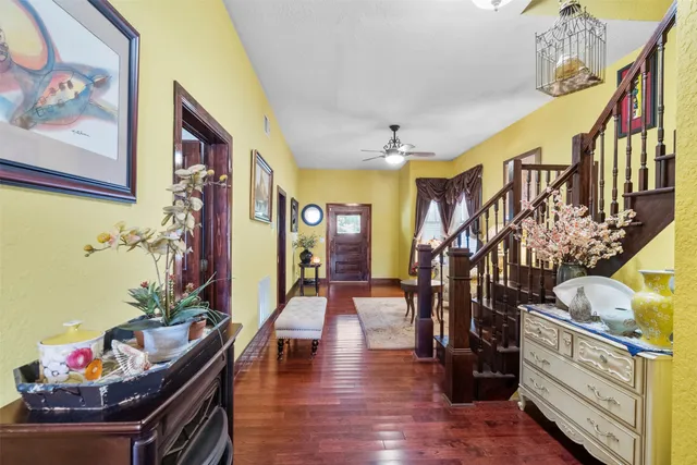 a living room with furniture and flowers