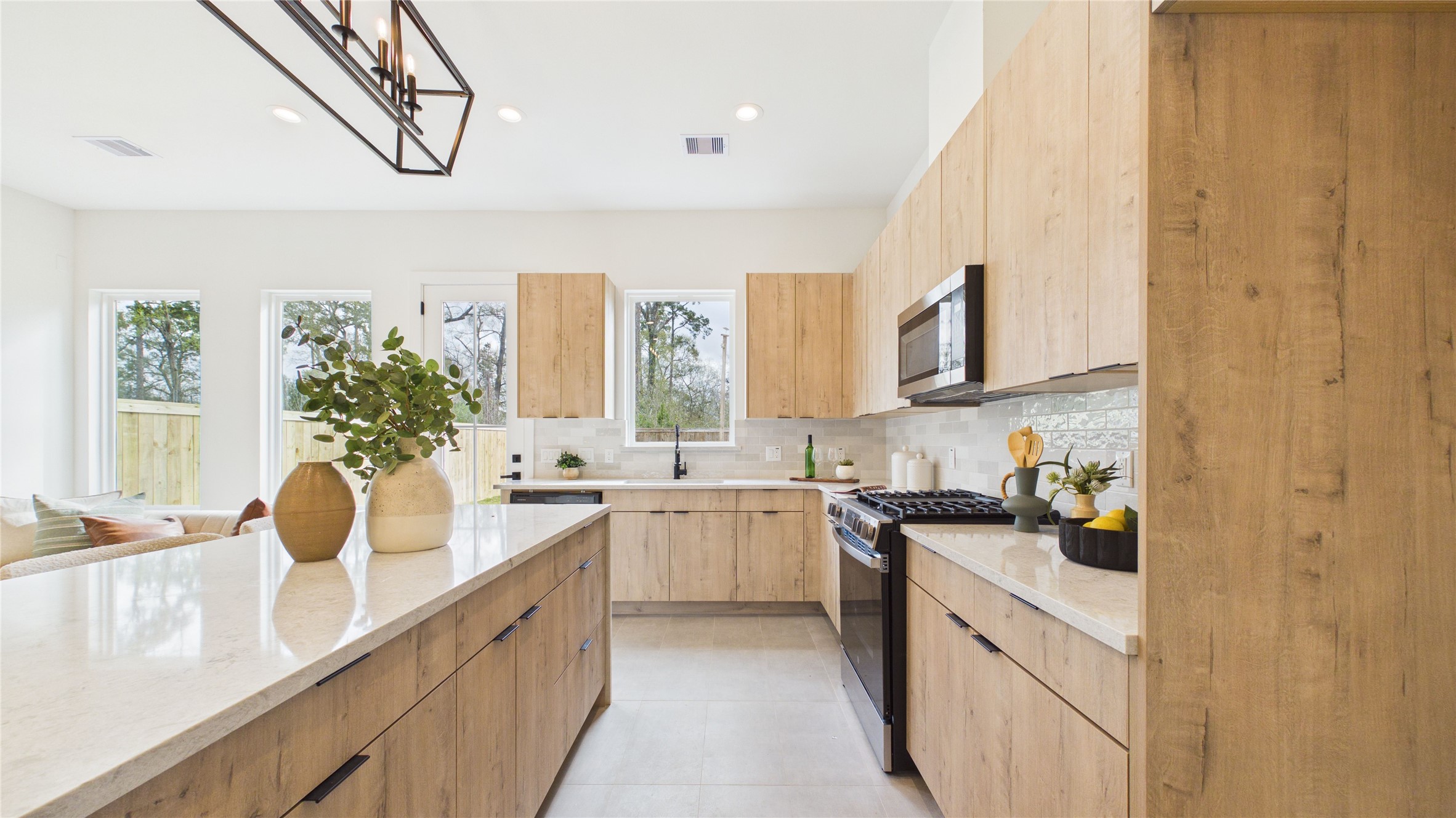 6058 Cebra Street Houston, TX 77091 - Photo 5 of 38 Soft-close cabinetry is a sleek arcadia yellow walnut.