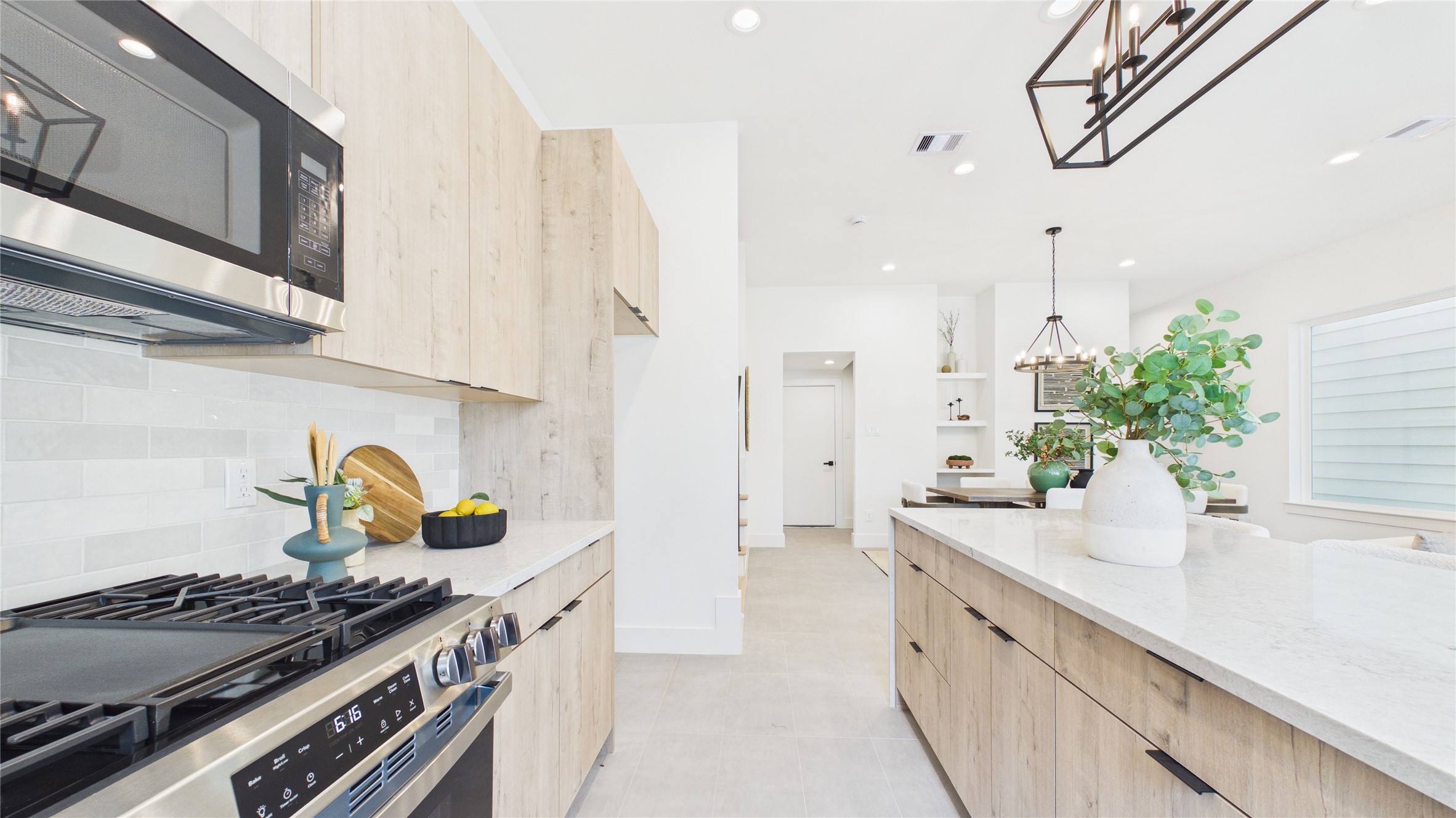 6058 Cebra Street Houston, TX 77091 - Photo 10 of 38 Stainless steel appliances complement the neutral tones of this stunning kitchen.