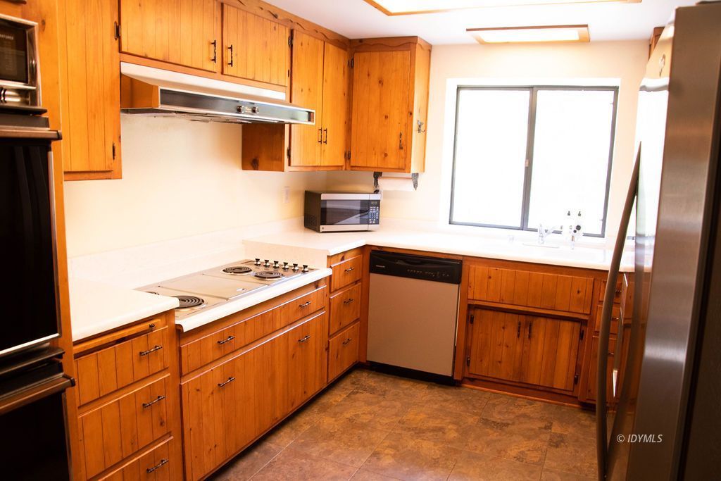 55441 Howland Road Idyllwild, CA 92549 - Photo 17 of 40 a kitchen with granite countertop cabinets stainless steel appliances and a window