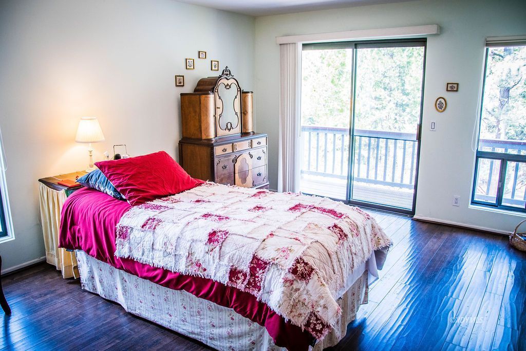 55441 Howland Road Idyllwild, CA 92549 - Photo 23 of 40 a bedroom with a bed and wooden floor