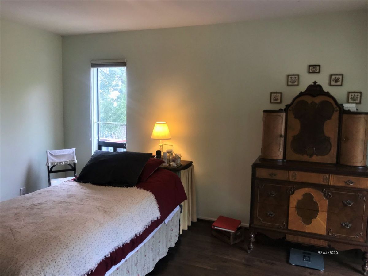 55441 Howland Road Idyllwild, CA 92549 - Photo 24 of 40 a bedroom with a bed and a fireplace