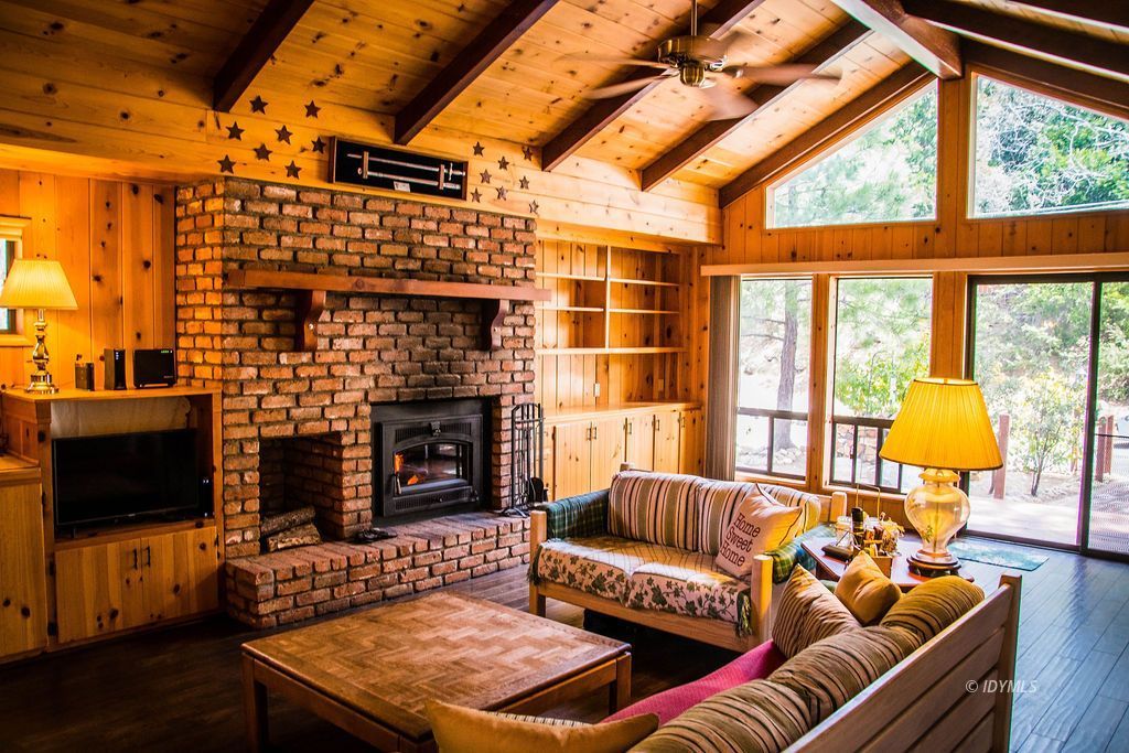 55441 Howland Road Idyllwild, CA 92549 - Photo 6 of 40 a living room with furniture a flat screen tv and a fireplace