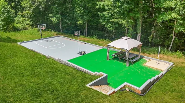a view of a room with wooden floor and ceiling fan