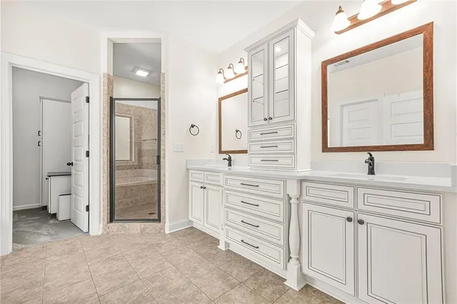 a view of an empty room with wooden floor and a ceiling fan