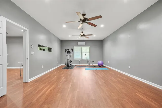 a bedroom with a bed and a ceiling fan