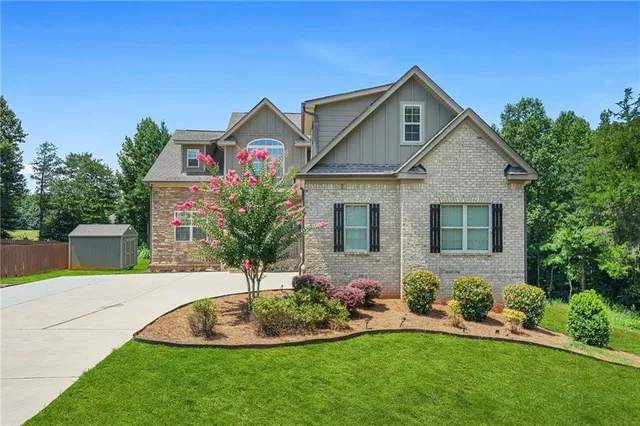 a front view of house with yard and green space
