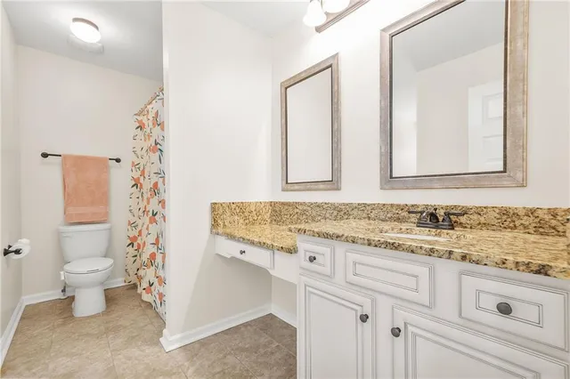 a bed sitting in a spacious bedroom next to a window