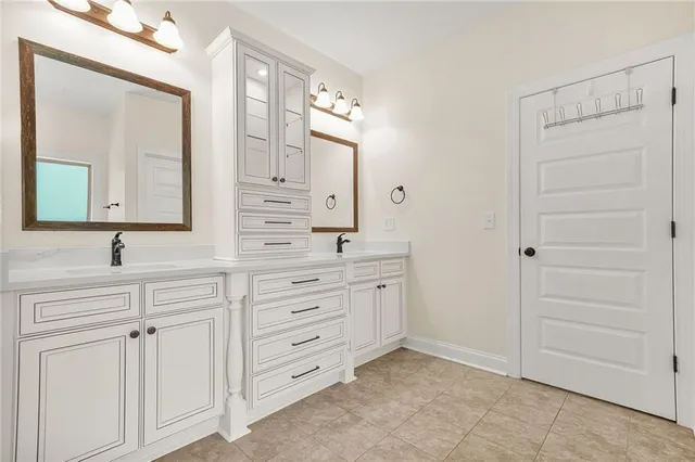 a porch with a table and chairs next to a yard