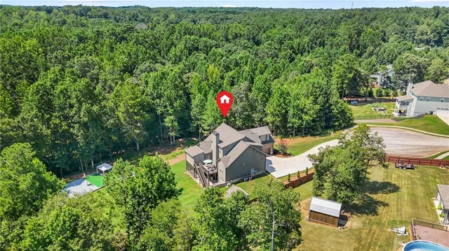 a view of a house with a yard and sitting area