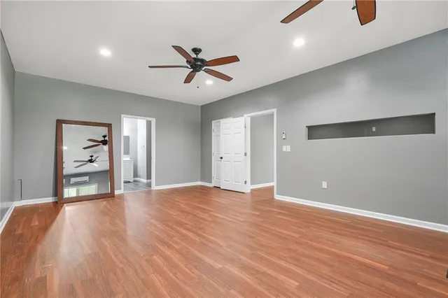 a bathroom with a granite countertop toilet sink and mirror