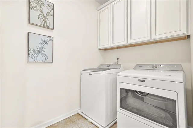 a spacious bedroom with a bed and dresser