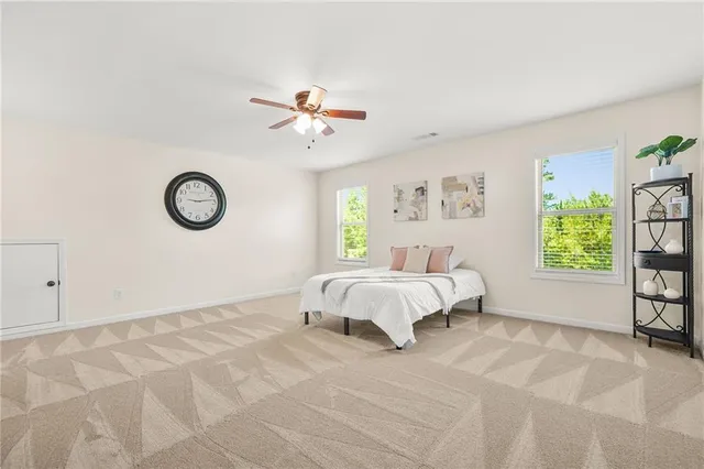 a bedroom with a large bed and a window